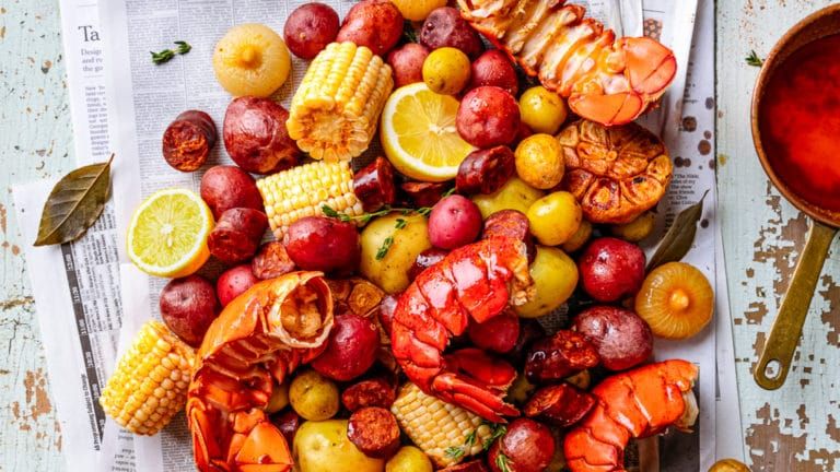 Seafood boil tray with lobster, shrimp, corn and potatoes